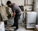 Técnico retirando caldera vieja y desembalando una nueva. Averigua cuanto cuesta cambiar una caldera de gas.